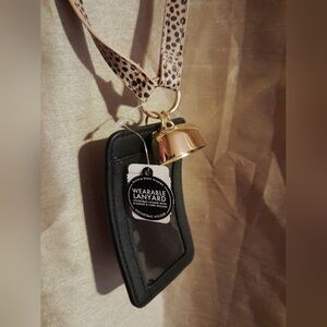 Wearable lanyard with pocket bac holder and ID badge and card holder.